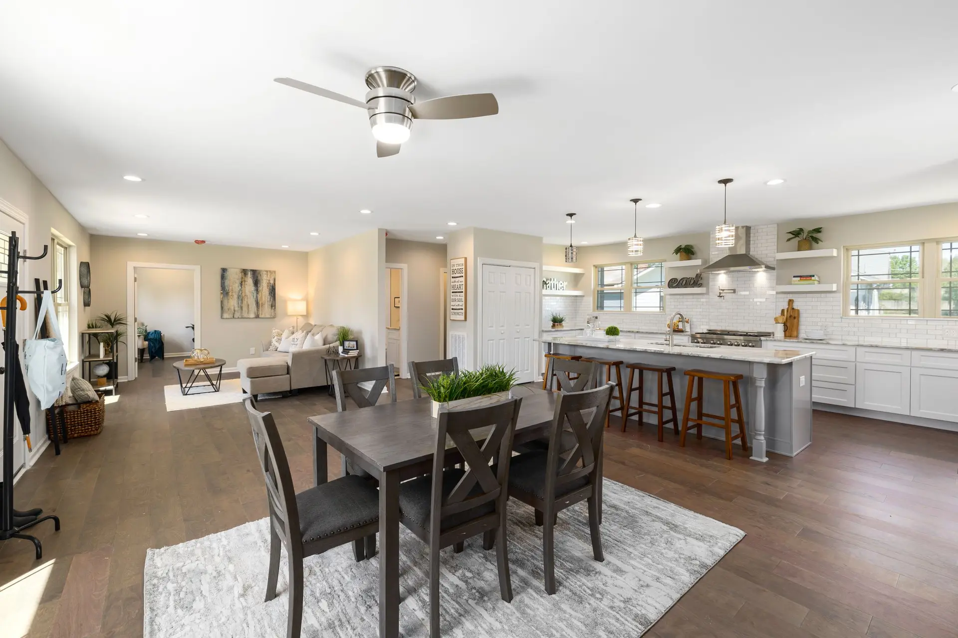 Open kitchen and living area with a long run of hardwood flooring
