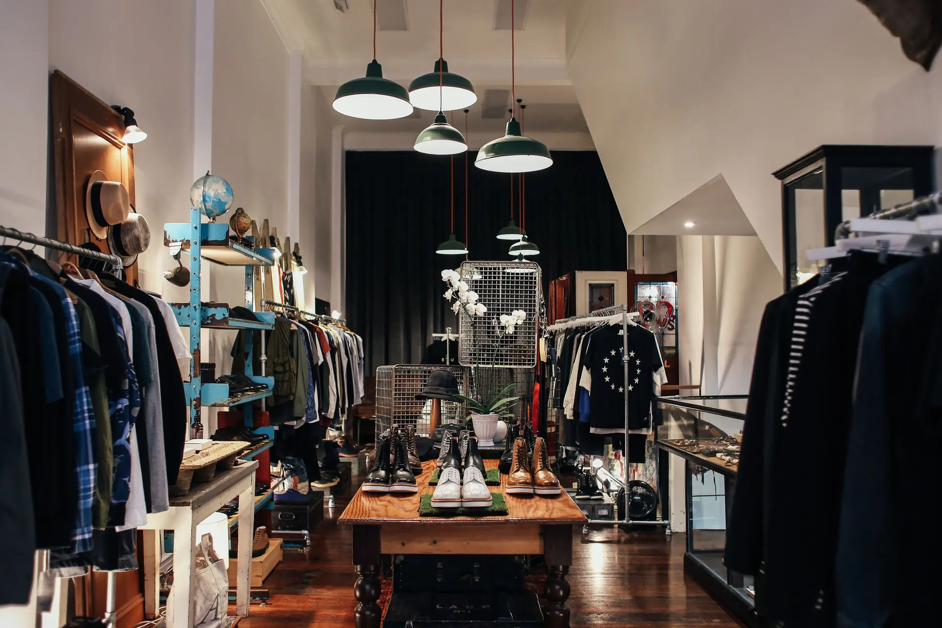 Clothing boutique with racks, pendant lights and a central display table